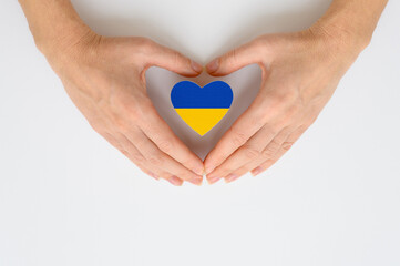 The national flag of Ukraine in female hands. The concept of patriotism, respect and solidarity...