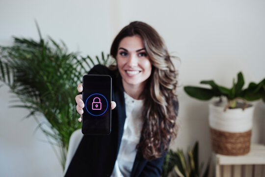 Businesswoman showing smart phone with padlock logo