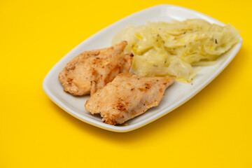 grilled chicken breast with boiled cabbage on the dish