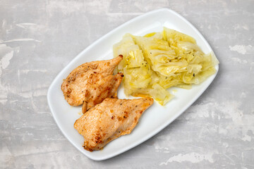grilled chicken breast with boiled cabbage on the dish