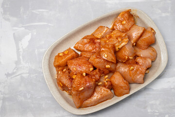 raw meat with marinate on brown dish on ceramic