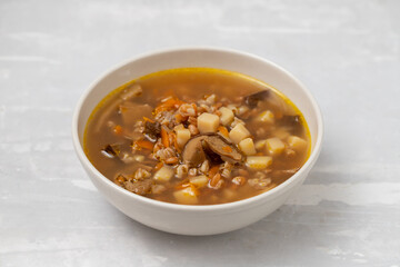 fresh mushrooms soup in small brown bowl