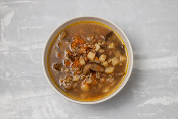 fresh mushrooms soup in small brown bowl