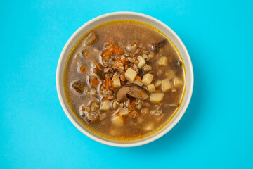 fresh mushrooms soup in small brown bowl
