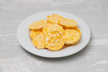 small puffed corn cakes on small white plate