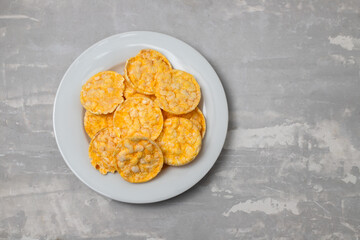 small puffed corn cakes on small white plate