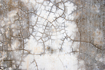 Cracked plaster wall texture, damaged walls exposed to sunlight and rain