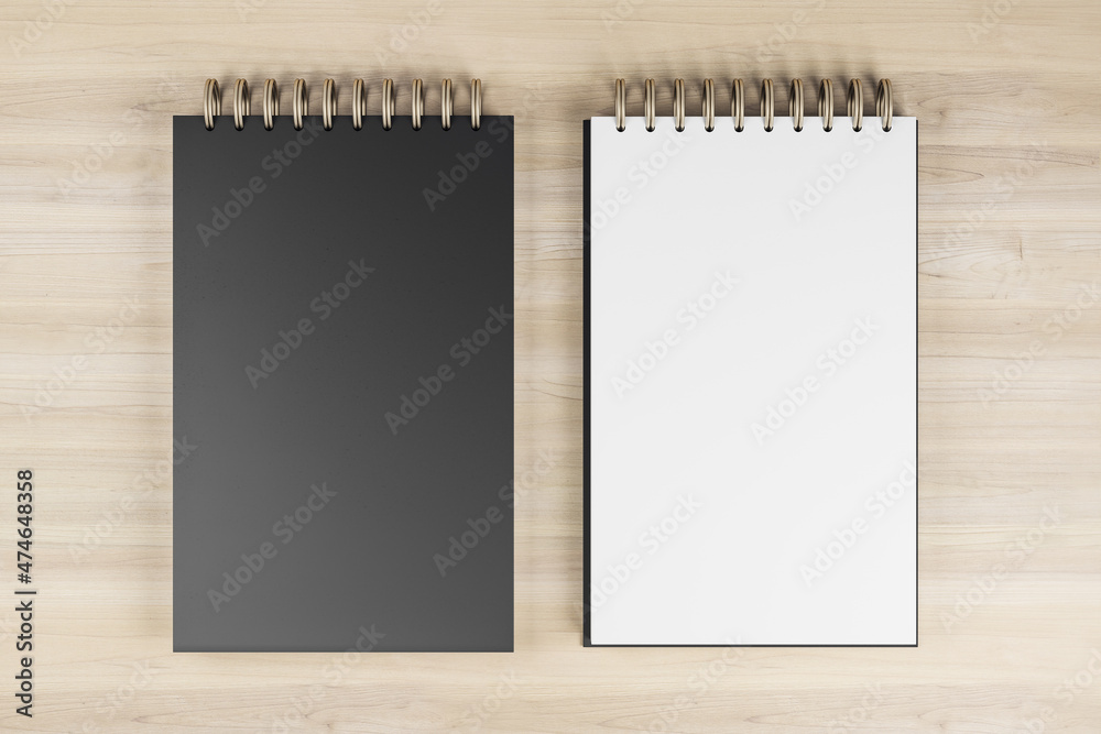 Aufkleber Top view and close up of two white and black spring notepads on wooden desktop background. Mock up place for your advertisement. Education, work, supplies and stationery concept. 3D Rendering.