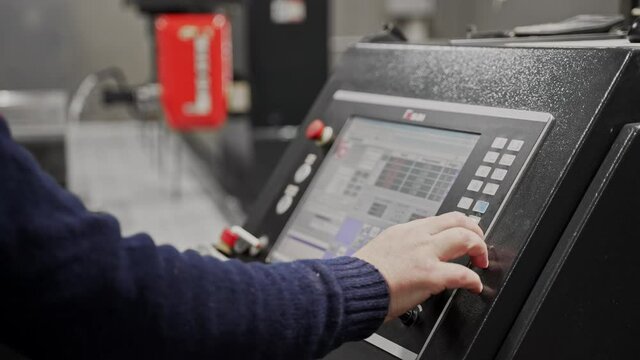 CNC control panel. The operator sets the program for computer numerical control, presses the touch screen