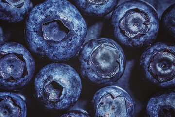 Close up of fresh blueberries on a wooden table, macro photography