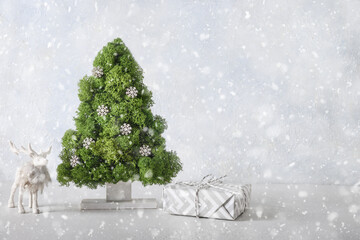 Creative alternative eco Christmas tree decorated green moss and snowflakes and reindeer on snowy...