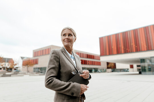 Businesswoman with tablet PC in city