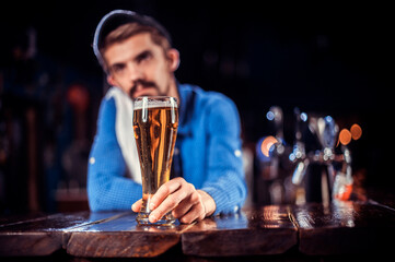 Bartender mixes a cocktail on the alehouse