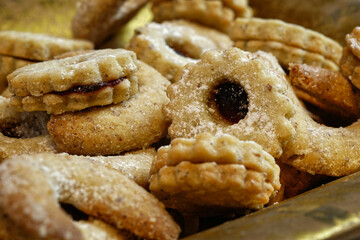 Homemade Christmas cookies in a vintage gold colored bowl. Close-up.