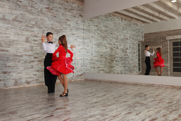 Beautifully dressed couple of kids dancing together in studio, space for text