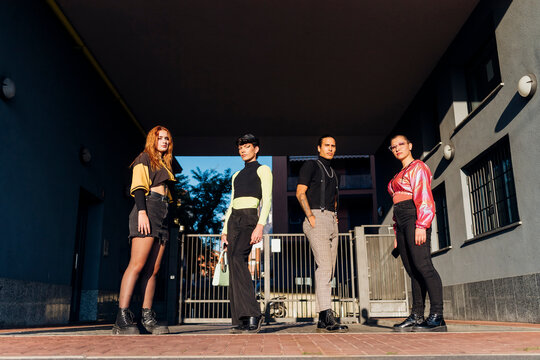 Friends standing at distant on footpath