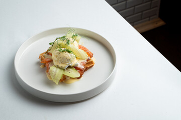 Healthy gourmet breakfast in a modern restaurant, matcha latte with salmon waffle, top view