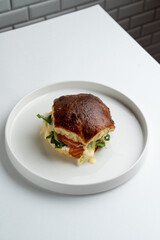 Sweet salmon bun on white dish, top view