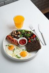 A whole portion of english breakfast, on white dish, top view, modern menu design