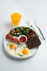 A whole portion of english breakfast, on white dish, top view, modern menu design