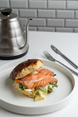 Smoked salmon bagel with lettuce and cream cheese, white modern new york coffee house
