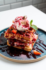 Soft waffles with berries and ice cream on vintage turquoise dash, white background menu photography