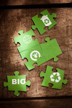 Green puzzle pieces with signs on table