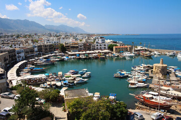 Fototapeta premium KYRENIA . CYPRUS.View from the fortress on the Cyrenian Harbor in the form of a horseshoe, the house of Kyrenia and the mountain.