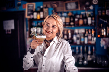 Experienced woman bartending demonstrates his skills over the counter on the bar