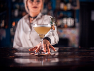 Young barmaid demonstrates his professional skills on the bar