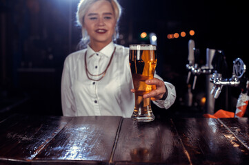 Girl bartender mixes a cocktail in the saloon