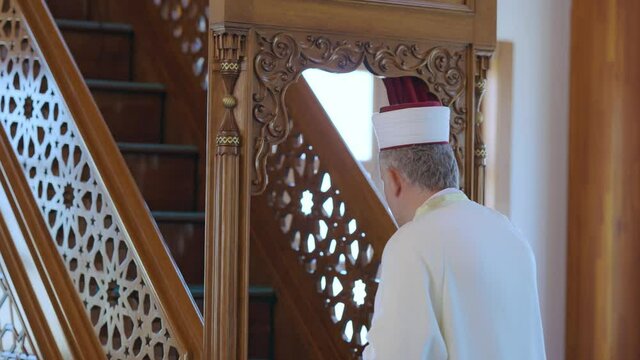Muslim cleric preparing to preach to the congregation at the mosque for Friday prayers. The Muslim cleric will explain to the congregation what it takes to be a good Muslim.