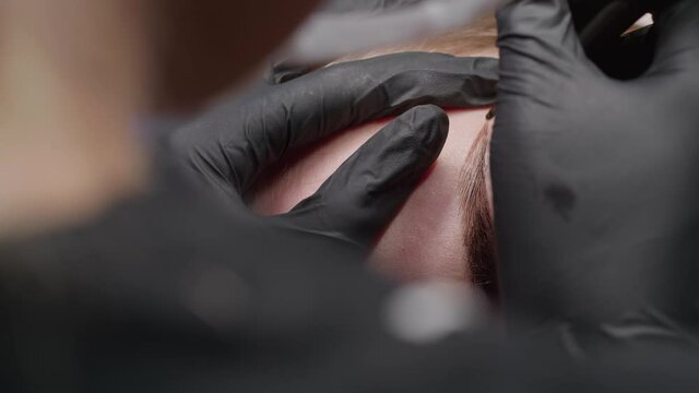 Close-up of permanent makeup on the eyebrows