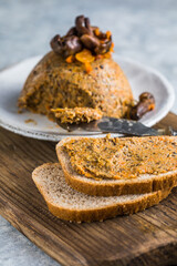 Vegetarian snack - beans and mushroom (honey mushrooms) pate on wooden board