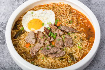 A basin of Korean instant noodles on a white background