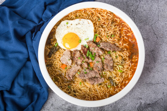 A basin of Korean instant noodles on a white background