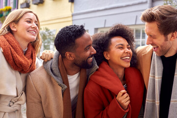 Outdoor Portrait Of Group Of Friends Wearing Coats And Scarves In Autumn Or Fall