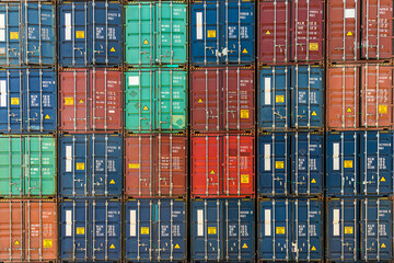 Stack of containers in a harbor.  Shipping containers stacked on cargo ship. Background of Stack of...