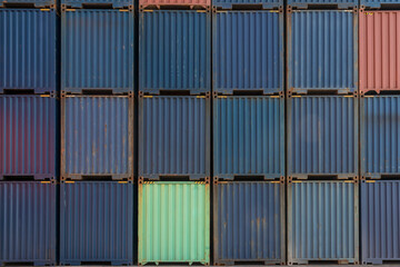 Stack of containers in a harbor.  Shipping containers stacked on cargo ship. Background of Stack of Containers at a Port.