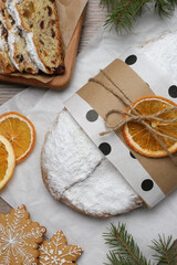 Decorated traditional Christmas Stollen on wooden table, flat lay