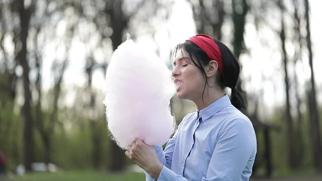 Woman candy. Eating. Park. Video. Female. 