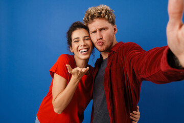 Young white couple gesturing while taking selfie photo