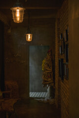 Dark hall in the coffee shop with antique lamps. Pictures on the wall. Cafe interior. High quality photo
