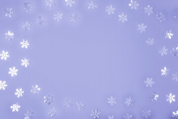 Abstract Christmas background in very peri color 2022. Violet confetti on a violet background, copy space for text