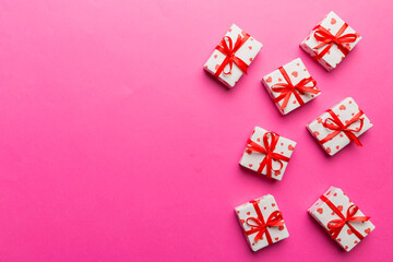 Valentine day composition: red gift box with bow and heart. Christmas present. View from above. Space for text. Holday greeting card