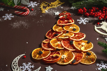 Festive fir tree from dried fruits. Christmas or New Year festive flat lay, food creative