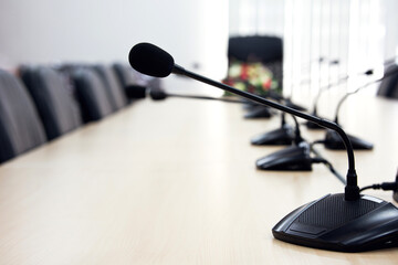 Conference microphone on conference table. Sound amplification equipment for communicating in...