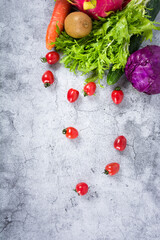 basket with fresh fruits and vegetables like pineaple,carrots,apples,tomatos and more