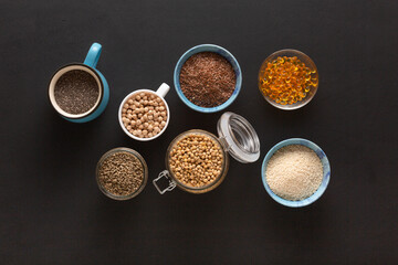 Source of vitamin E and nutrients in bowls on the table, copy space