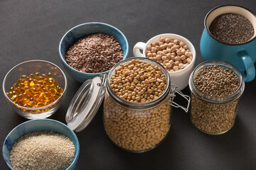 Source of vitamin E and nutrients in bowls on the table, copy space
